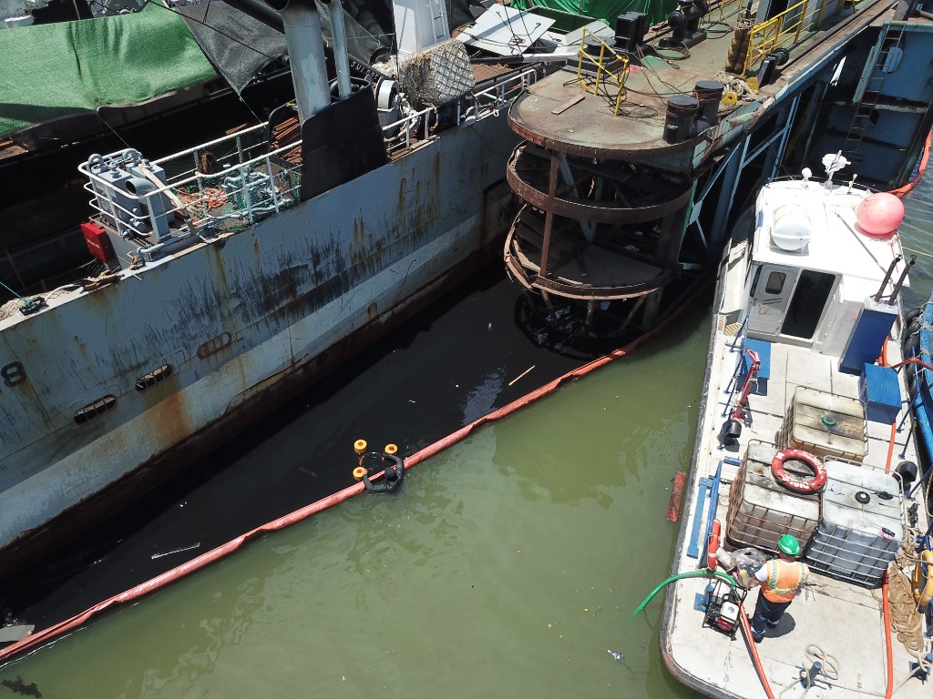 Containment beside hull in port area